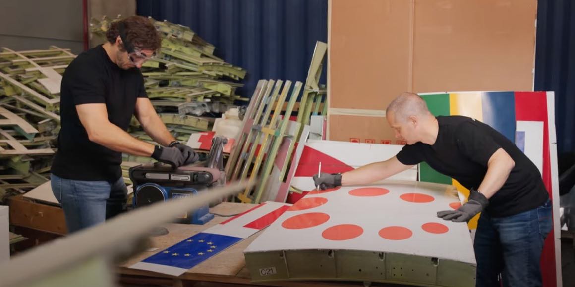Patrik and Ralph carry panels from the store to the bench, where the cutting lines go on.