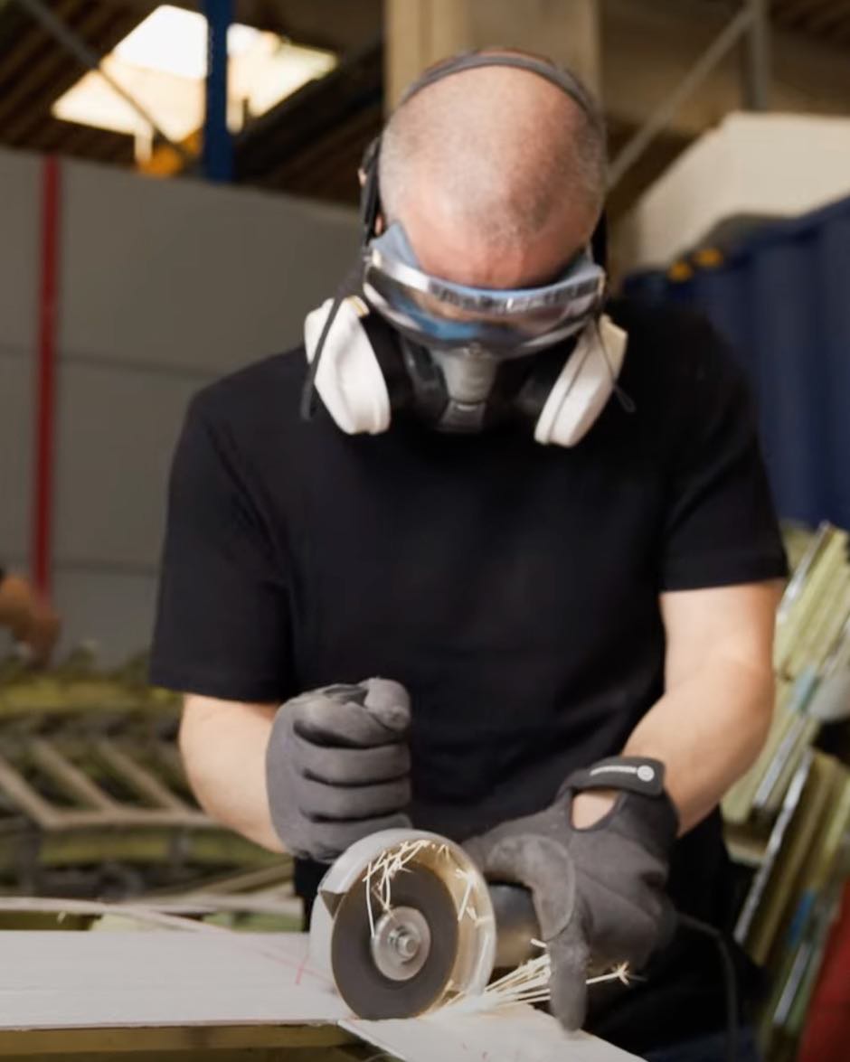 Ralph Wansch separating the skin from the stringers with an angle grinder.