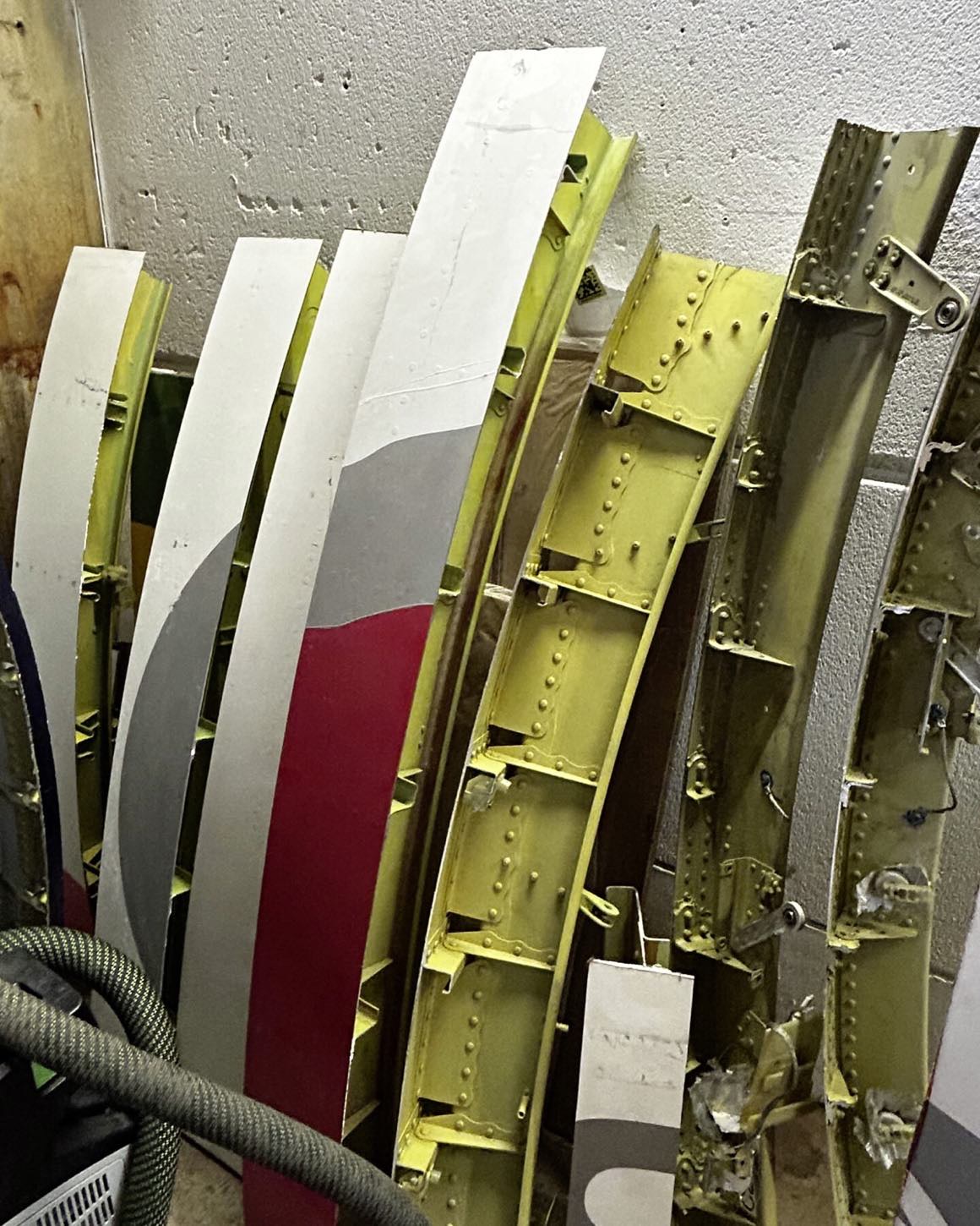 Skin panels and stringers, lined up after removal.